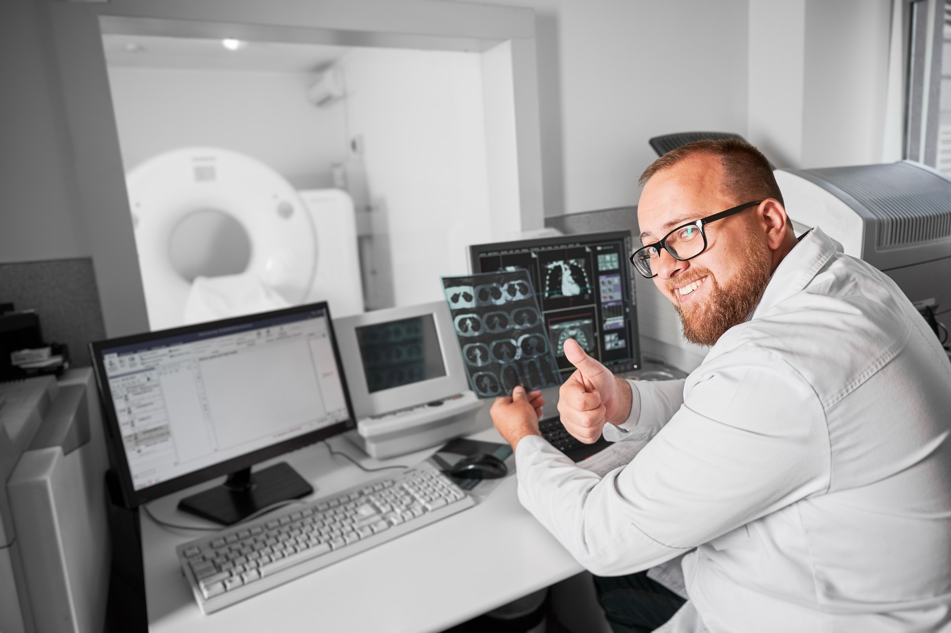 Doctor sitting at computer, making MRI.